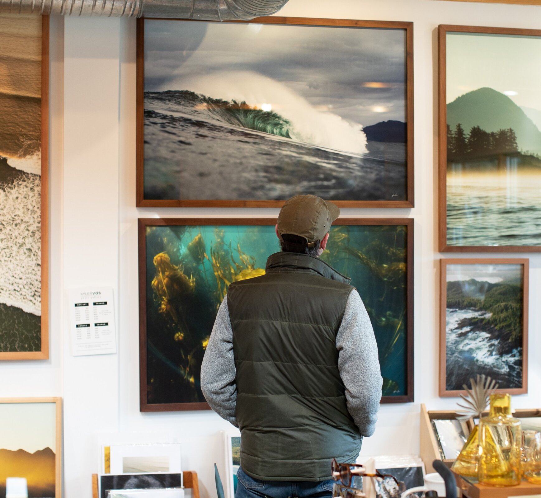 Shopper looking at the works of photography on the gallery wall